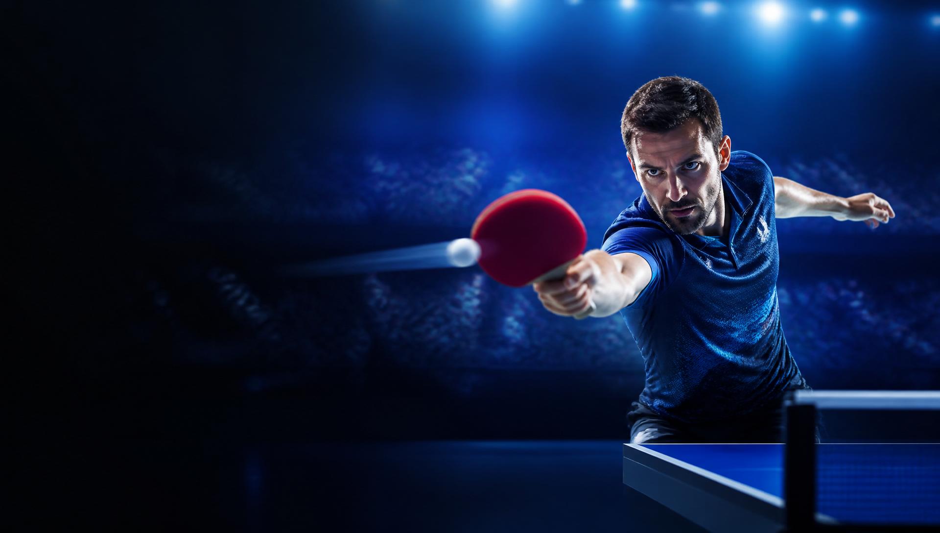 Professional table tennis player in championship action under arena lights